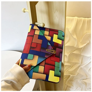 Close-up of envelope clutch bag with colorful geometric patterns and gold buckle