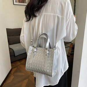 Silver woven crossbody tote bag with minimalist checkerboard texture and top handles