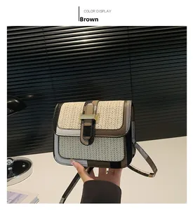 Detail of woven straw crossbody bag featuring tricolor leather trim and gold buckle