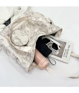 Large cream tote bag with bear print showing spacious interior with umbrella and cup
