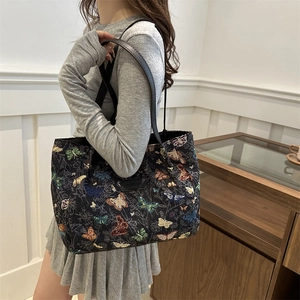 Large butterfly print tote bag with black leather straps and retro aesthetic for daily use