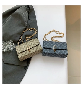 Detailed close-up of clover monogram pattern cross-body bags with gold chain and metal lock