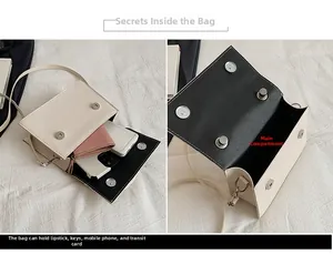 Vue détaillée du compartiment intérieur et du fermoir magnétique du sac en cuir ivoire