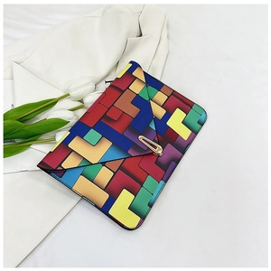 Detailed view of fashion envelope bag featuring colorful geometric print and gold metal lock