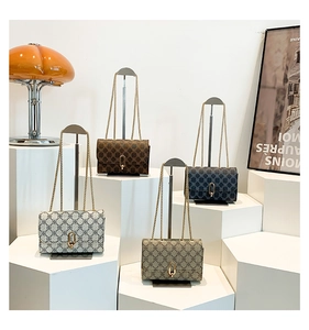 Detail of four colorful chain square bags with geometric patterns and gold chain straps