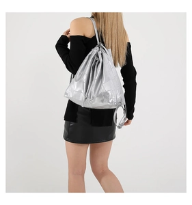 Detail of silver metallic bucket bag featuring square patchwork texture and drawstring
