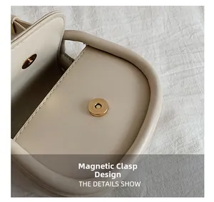Detail shot of the beige leather shoulder bag showing the golden magnetic closure design