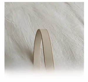 Detailed close-up of cream PU leather shoulder strap with smooth oil-edged finish