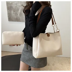 Dettaglio del set borsa tote bianco sporco grana litchi con tracolla in catena e pelle