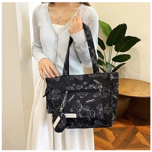 Detail of black tote bag with white bear prints and attached round coin purse