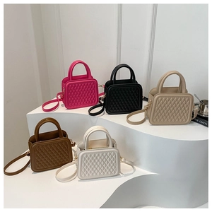 Detailed display of mini quilted crossbody bags in five colors with top handle and strap