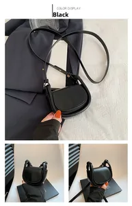 Detail view of the vintage black saddle bag with adjustable shoulder strap and flap closure