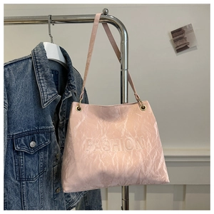Detail of pink faux leather tote bag showing embossed FASHION logo and marble texture