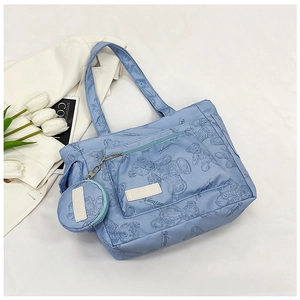 Detail of light blue nylon tote bag with bear print and matching round coin purse charm