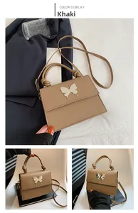 Détail du sac bandoulière kaki avec boucle papillon argentée et poignée nouée