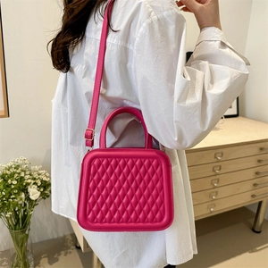 Chic rose red quilted crossbody bag with top handle and adjustable shoulder strap