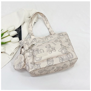 Detail view of large capacity canvas tote bag with gray bear print and round coin purse