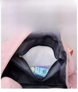 Internal view of pink quilted travel bag showing waterproof wet and dry compartment