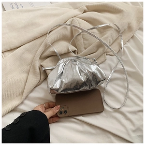 Detail of silver pleated cloud bag with metallic crackle texture and slim leather strap