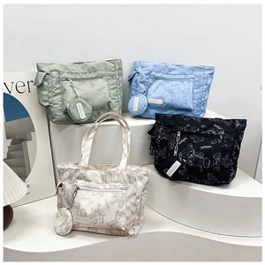 Detailed collection of floral printed tote bags in four pastel colors on display stand