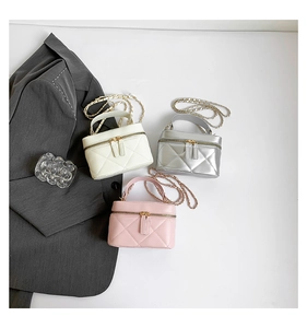 Detailed overhead view of quilted chain mini bags in beige, silver, and pink leather