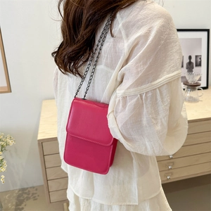 Chic rose pink vertical mini phone bag with sleek chain strap and flap closure design