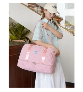Pink quilted travel bag featuring independent shoe compartment and dry-wet separation