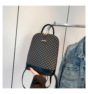 Detail of mini backpack featuring geometric pattern with black leather and gold hardware