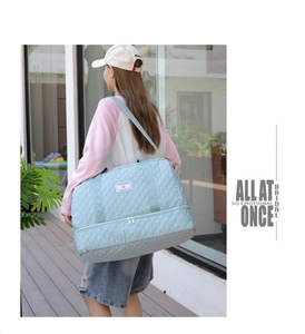 Close-up of quilted light blue travel bag with separate bottom shoe compartment and strap