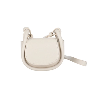 Minimalist cream beige saddle bag with unique cylindrical handle and adjustable shoulder strap