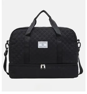 Quilted black travel bag detail showing bottom shoe compartment and wet dry separation zone