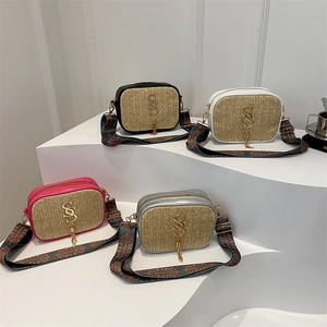 Chic woven straw crossbody bag with PU trim, wide ethnic strap and gold letter pendant
