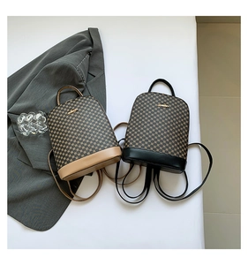 Detail of checkered mini backpacks with gold metal logos on a stylish grey background