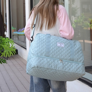 Quilted light blue travel bag with large capacity and bottom shoe compartment