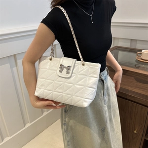 White quilted chain shoulder bag for women with silver bow clasp and leather strap
