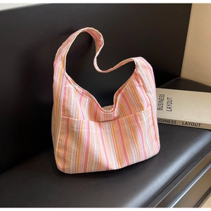 Detail of colorful striped nylon shoulder bag with side pocket on a leather seat