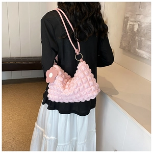 Pink bubble textured shoulder bag with floral charm and gold metal rings detail