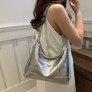 Silver tote bag with 3D metal butterflies and textured faux leather finish for women