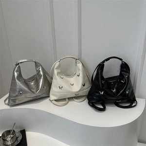 Chic underarm tote bag with silver butterfly charms in silver, white, and black colors