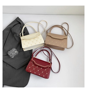 Close-up of quilted PU leather small square bags with heart stitching in three colors