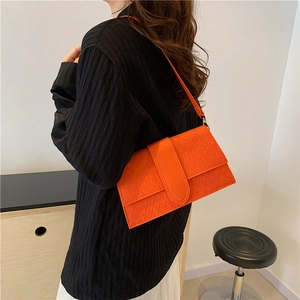 Sac bandoulière orange vif avec motif géométrique en triangle et bandoulière cuir