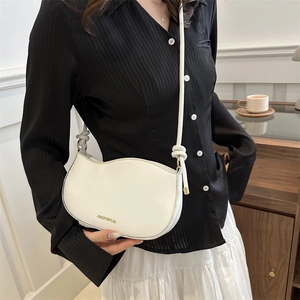 Minimalist white half-moon crossbody bag with slim strap and knotted detail for women