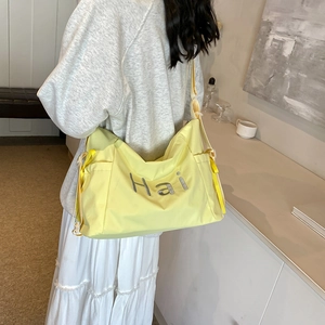 Large light yellow canvas tote bag with gray Hai letter embroidery and adjustable strap