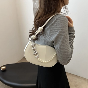 Fashionable creamy white semi-circle shoulder bag with pearl heart chain and knot strap