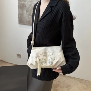 Beige pleated shoulder bag with Chinese style floral embroidery and tassel detail