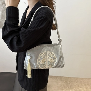 Embroidered silk crossbody bag with floral pattern and decorative long tassel pendant