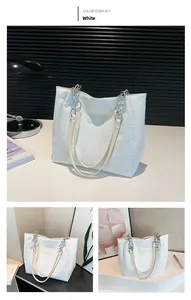 Detail of white woven tote bag with dual chain straps and Fashion brand label tag
