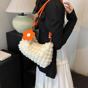 Chic bubble texture shoulder bag in cream white with vibrant orange strap and floral charm