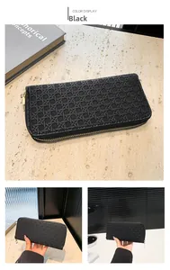Detail of black woven texture clutch wallet with premium gold zipper on stone surface