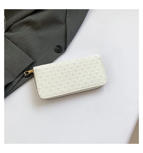 Close-up of white woven texture long wallet with high-quality golden zipper closure